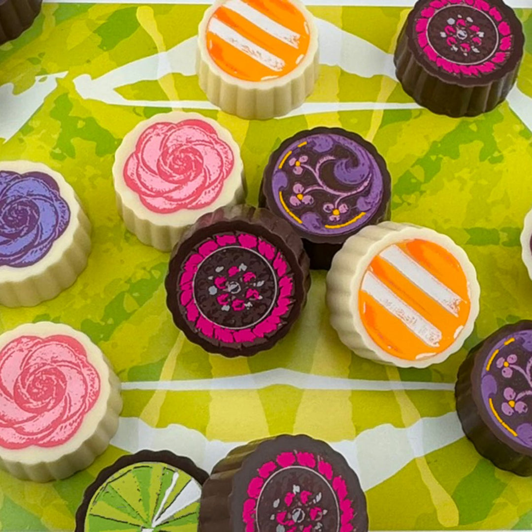 Timothy Adams Fruits and Florals chocolate truffle collection — handcrafted with Valrhona chocolate, infused with vibrant fruit and delicate floral flavors, presented in couture-inspired packaging.