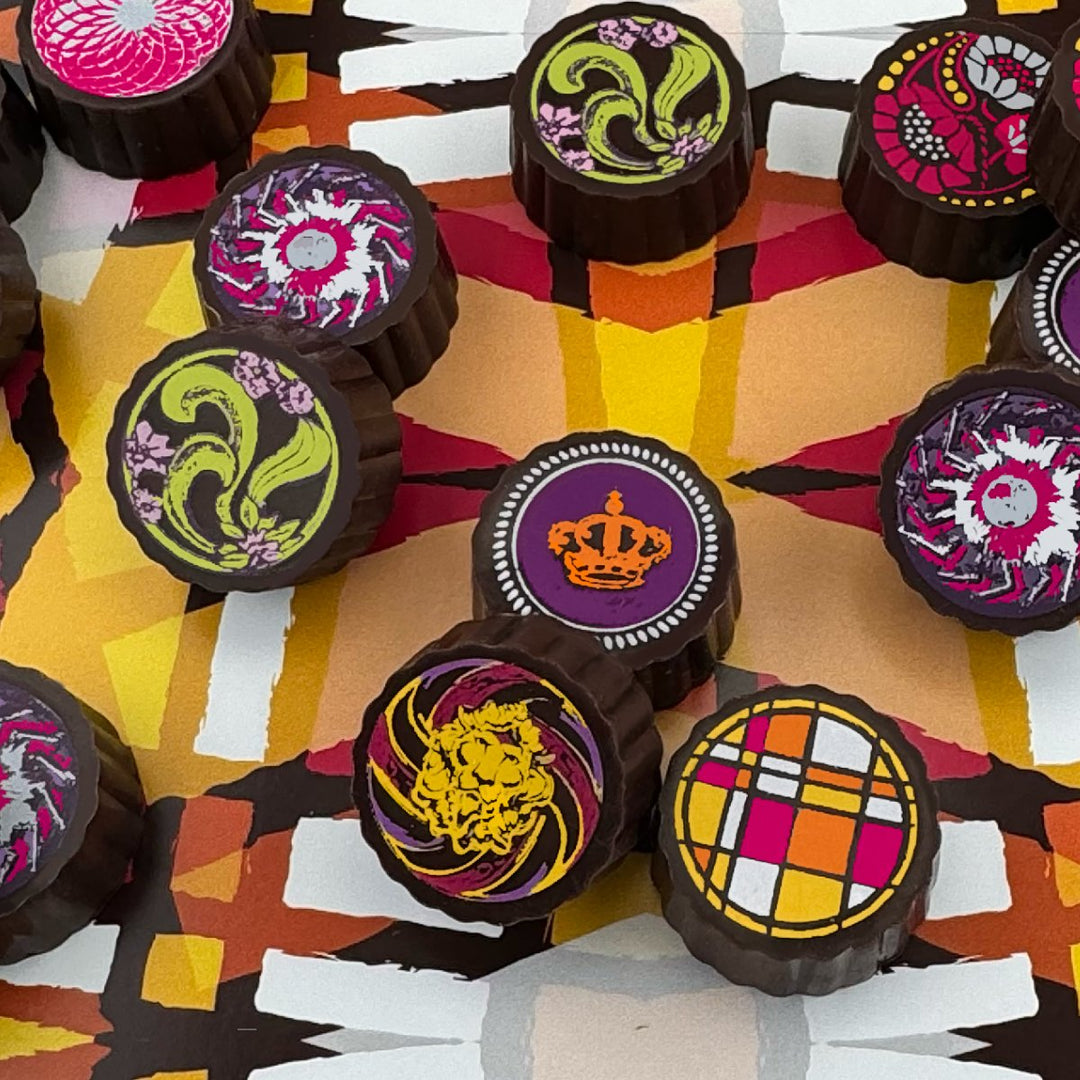 Luxury chocolate truffles with roasted nuts and silky caramel, handcrafted by Timothy Adams Chocolates in elegant couture-inspired packaging.
