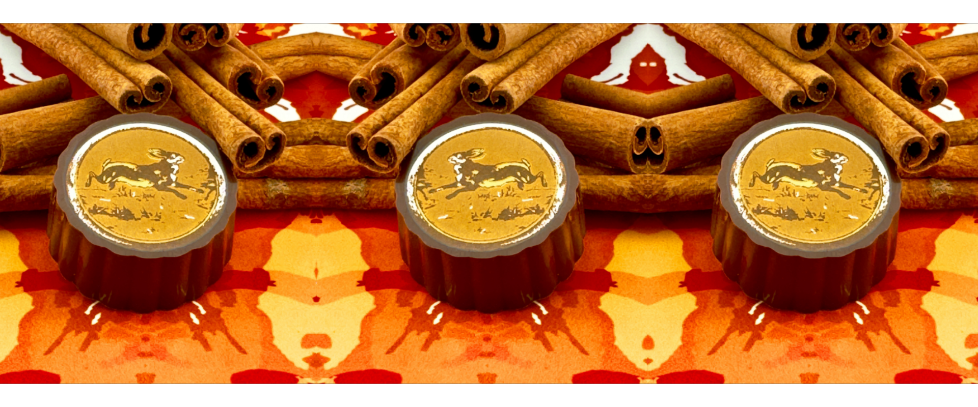 A rich piece of Valrhona chocolate infused with cinnamon, resting among warm cinnamon sticks