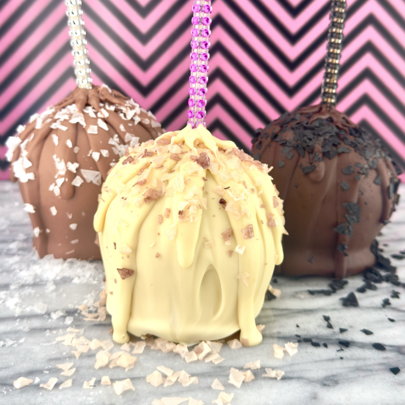 Handcrafted caramel apple dipped in rich chocolate, sprinkled with sea salt, and topped with a rhinestone straw. Limited edition Halloween treat, in-store only.