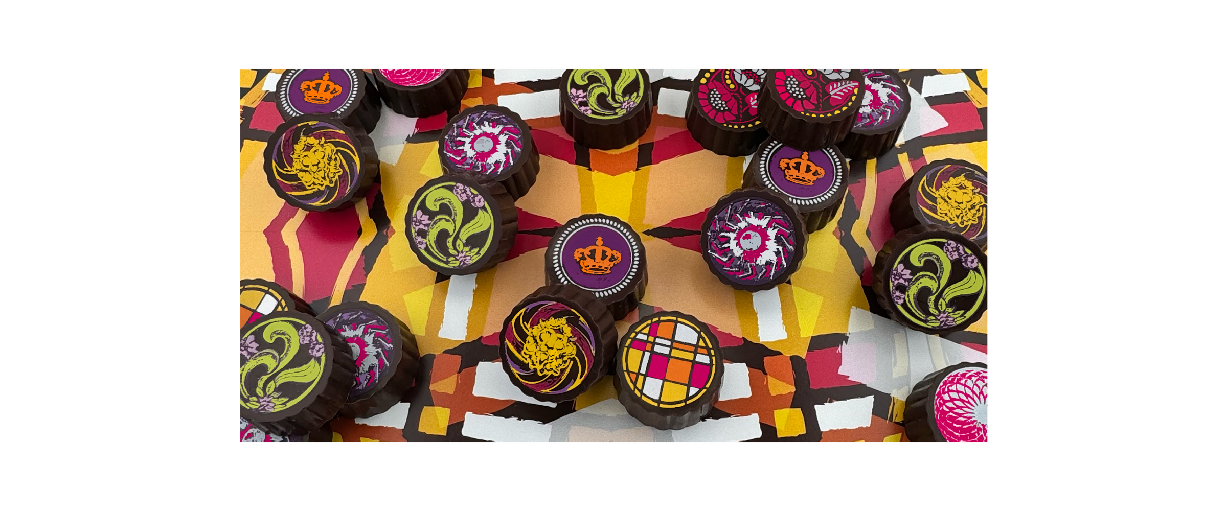 Luxury chocolate truffles with roasted nuts and silky caramel, handcrafted by Timothy Adams Chocolates in elegant couture-inspired packaging.