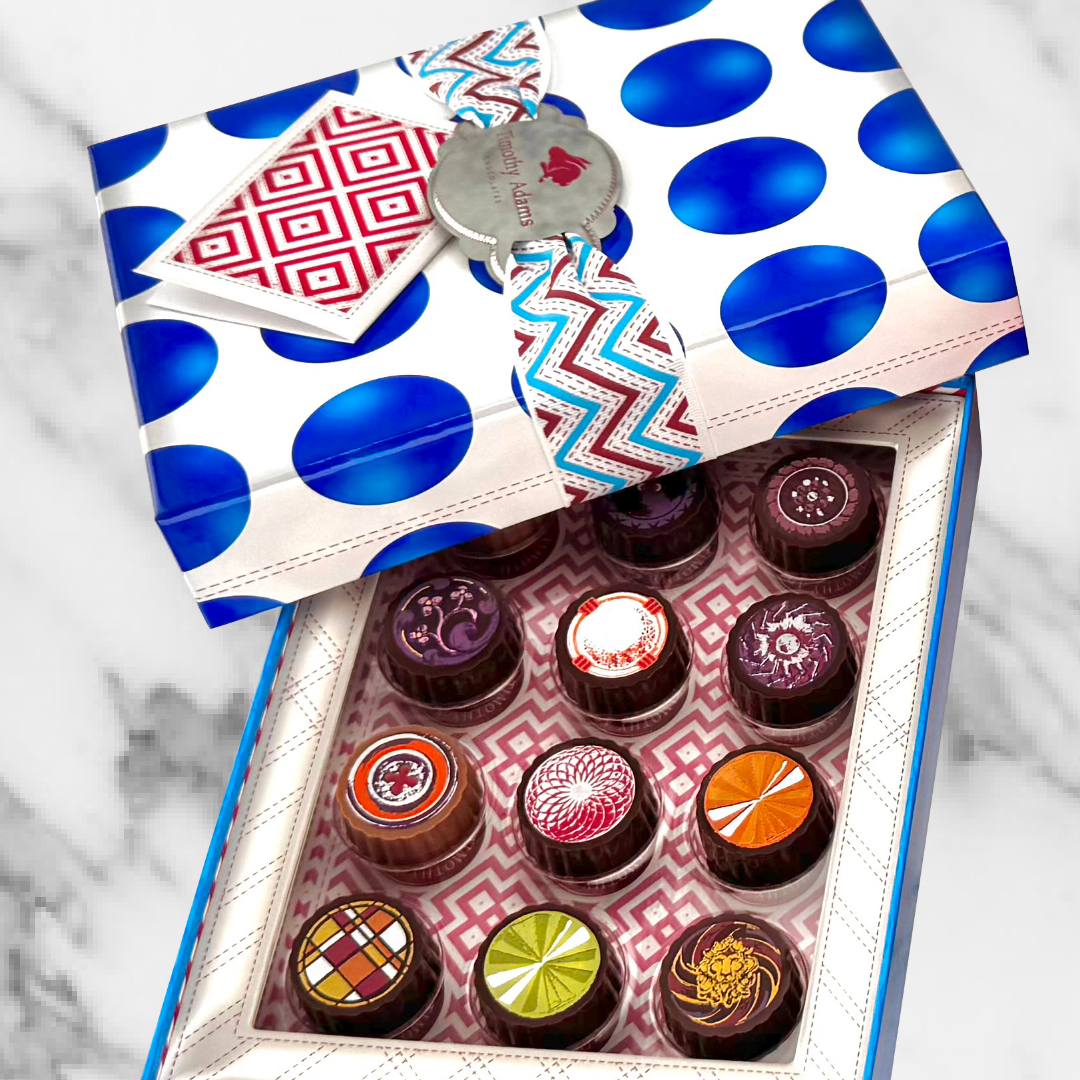Timothy Adams Twelve-Piece Chocolate Gift Box with colorful hand-crafted bonbons and patterned blue ribbon packaging.